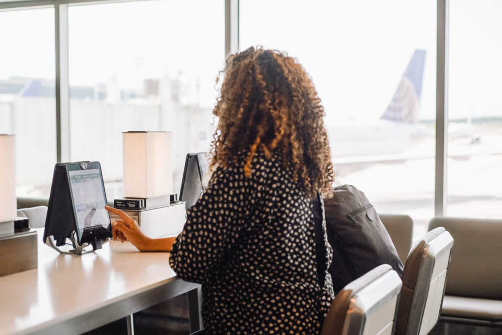 Woman using tablet at the boarding gate of an airport