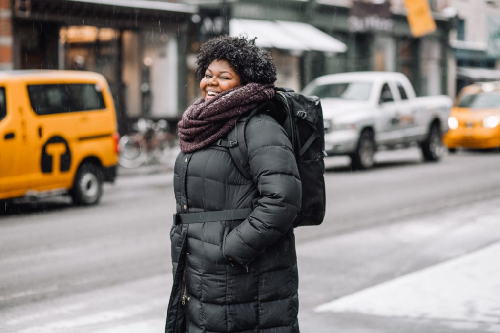 Woman wearing winter coat while traveling in New York City