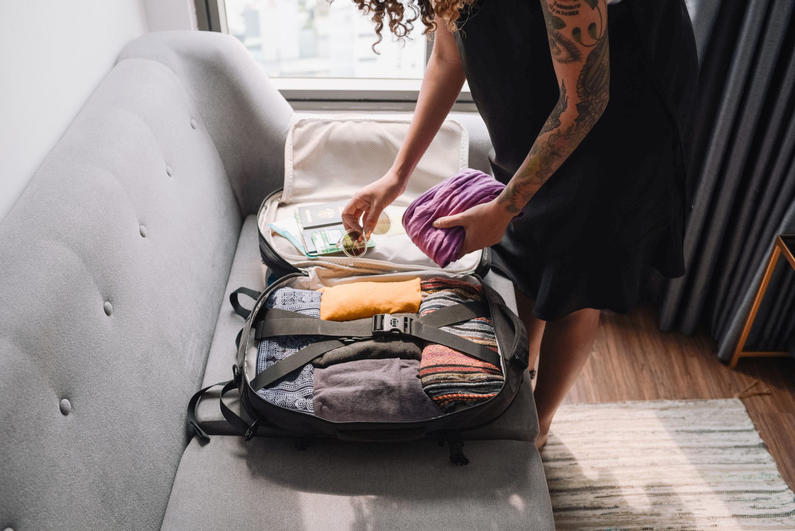Woman packing a carry on backpack