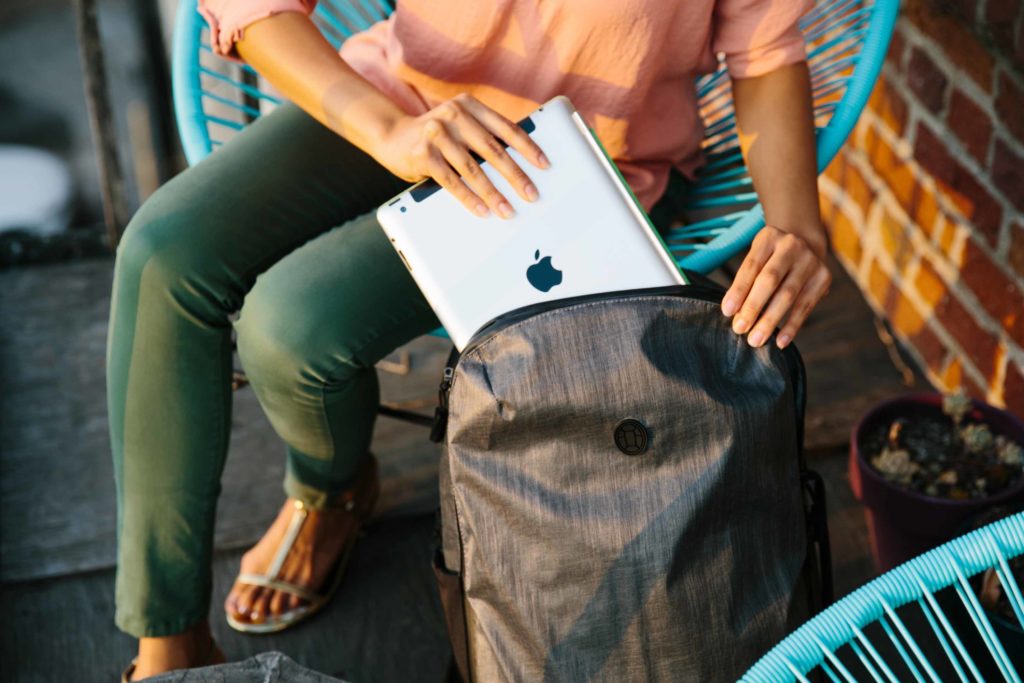 Sliding laptop into travel backpack