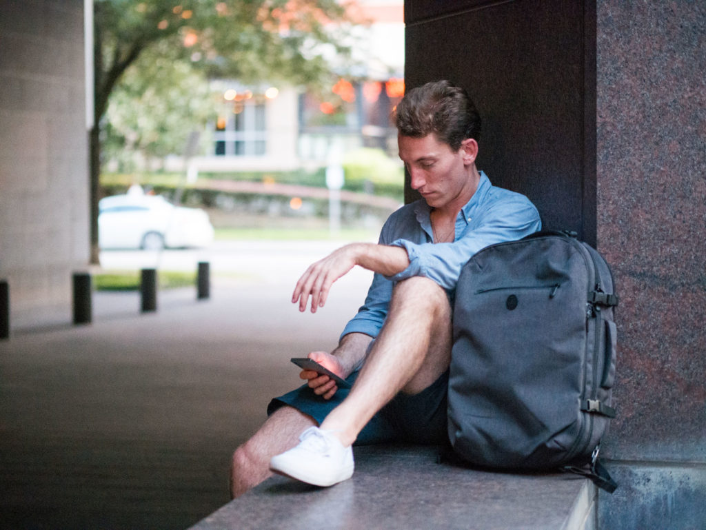 Man summer casual street fashion in New York. Wearing black tank