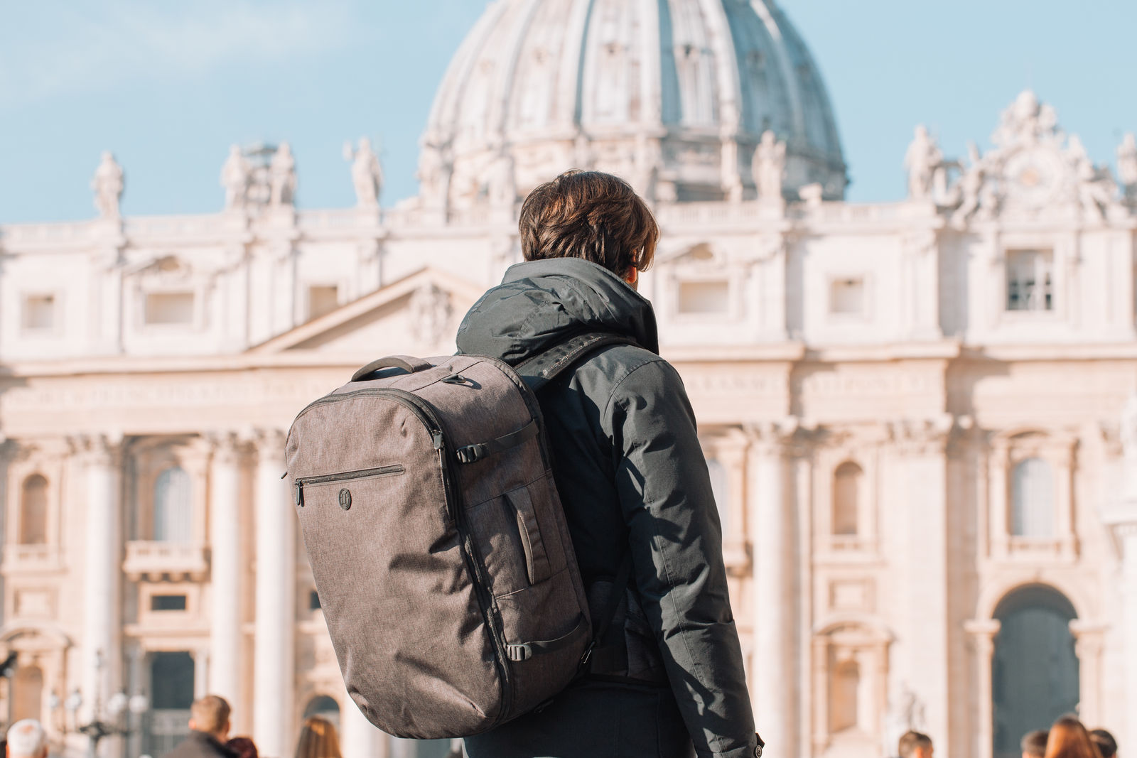 A man with an Outbreaker Backpack in Italy.