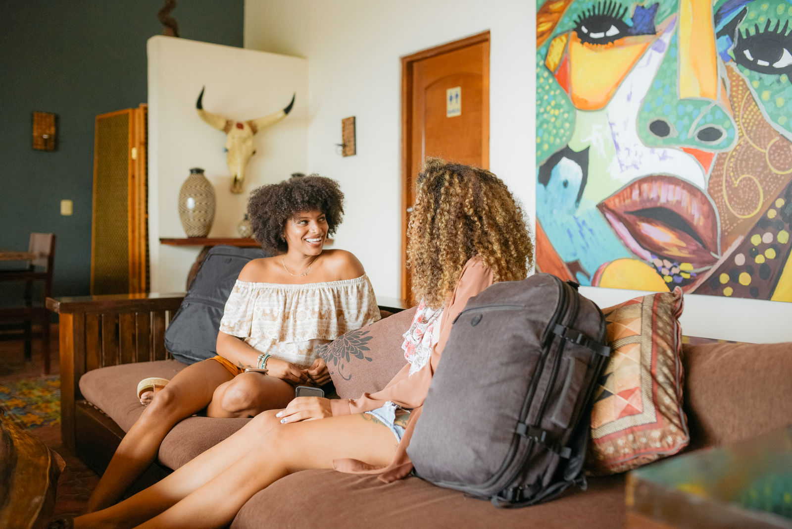 Women sitting on a couch in an Airbnb