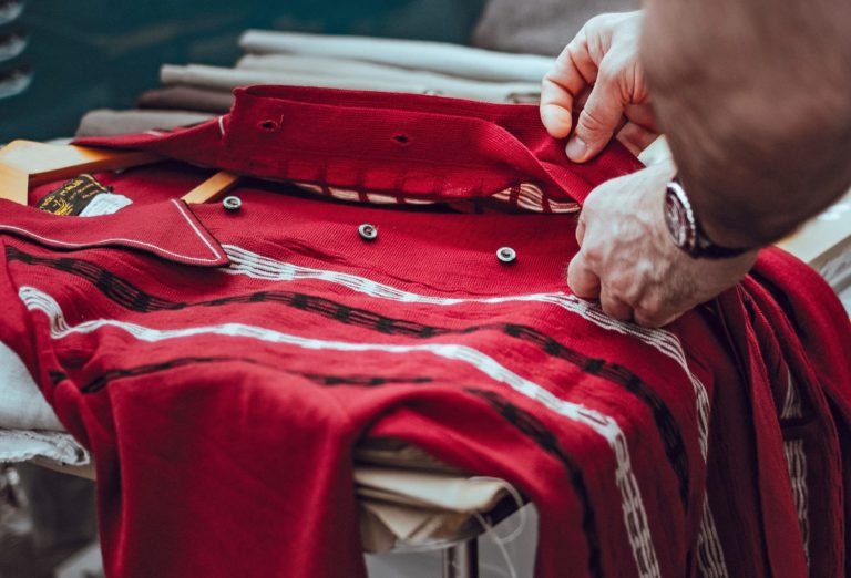 Buttoning up a red shirt