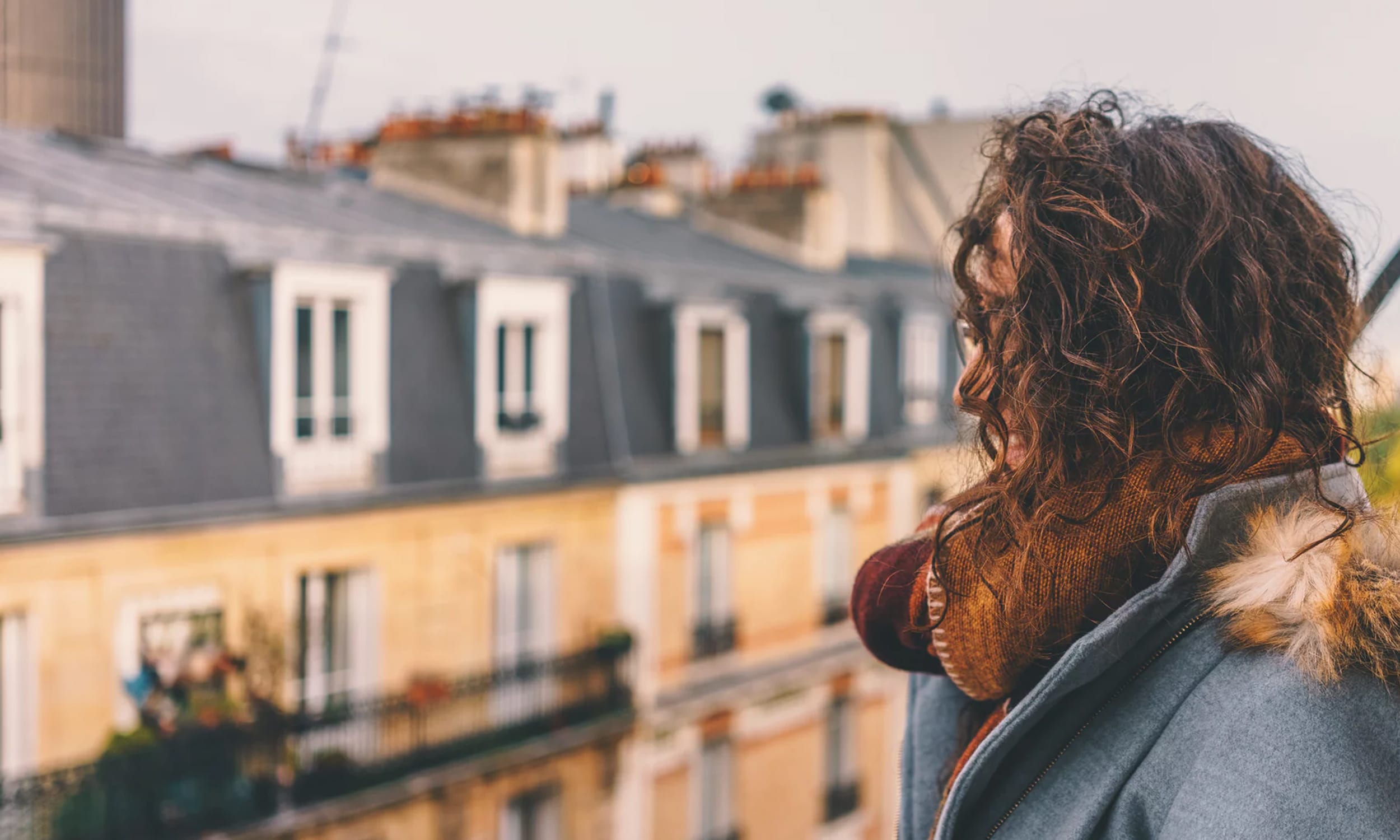 a woman looks over the streets of Paris