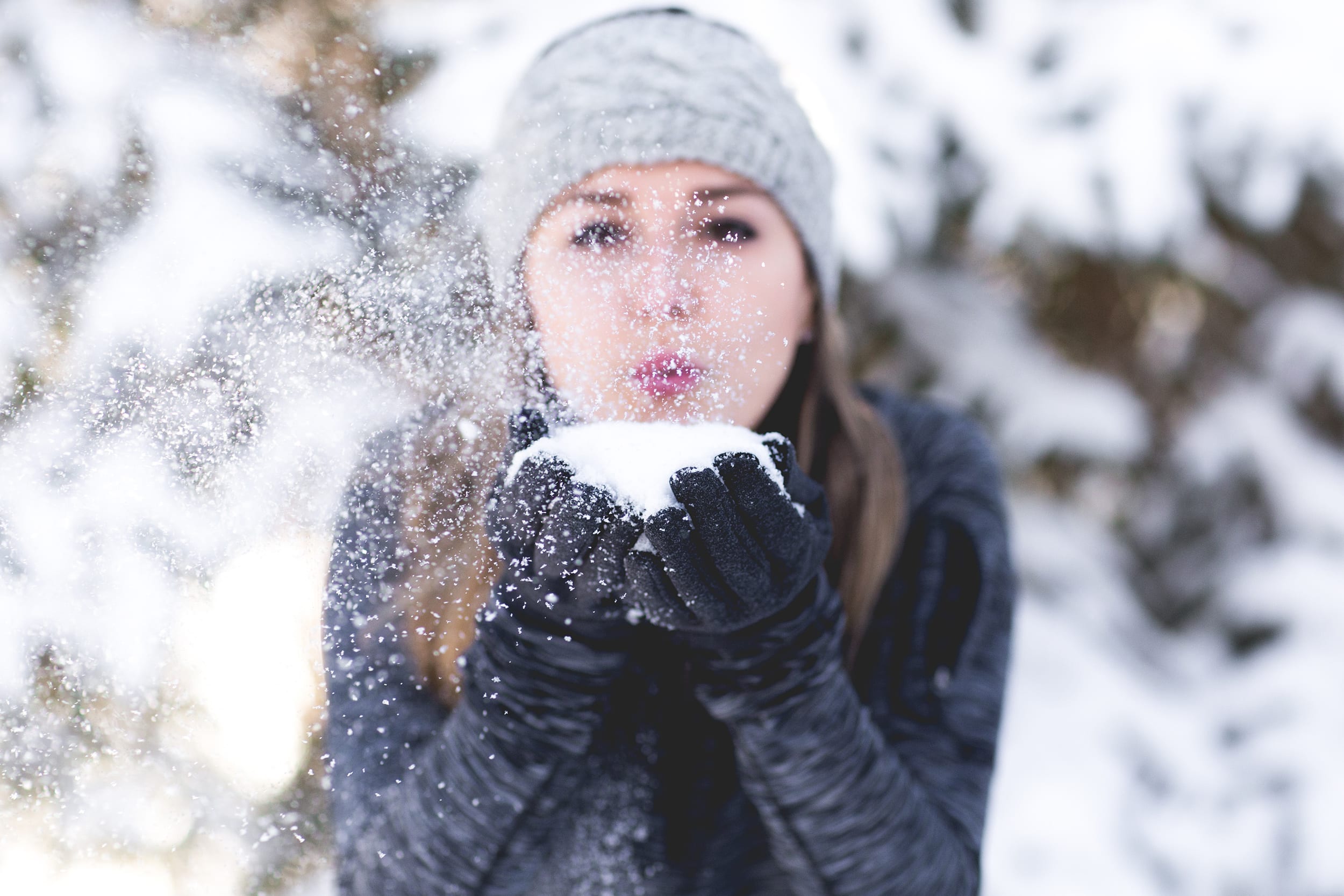 woman blowing snow
