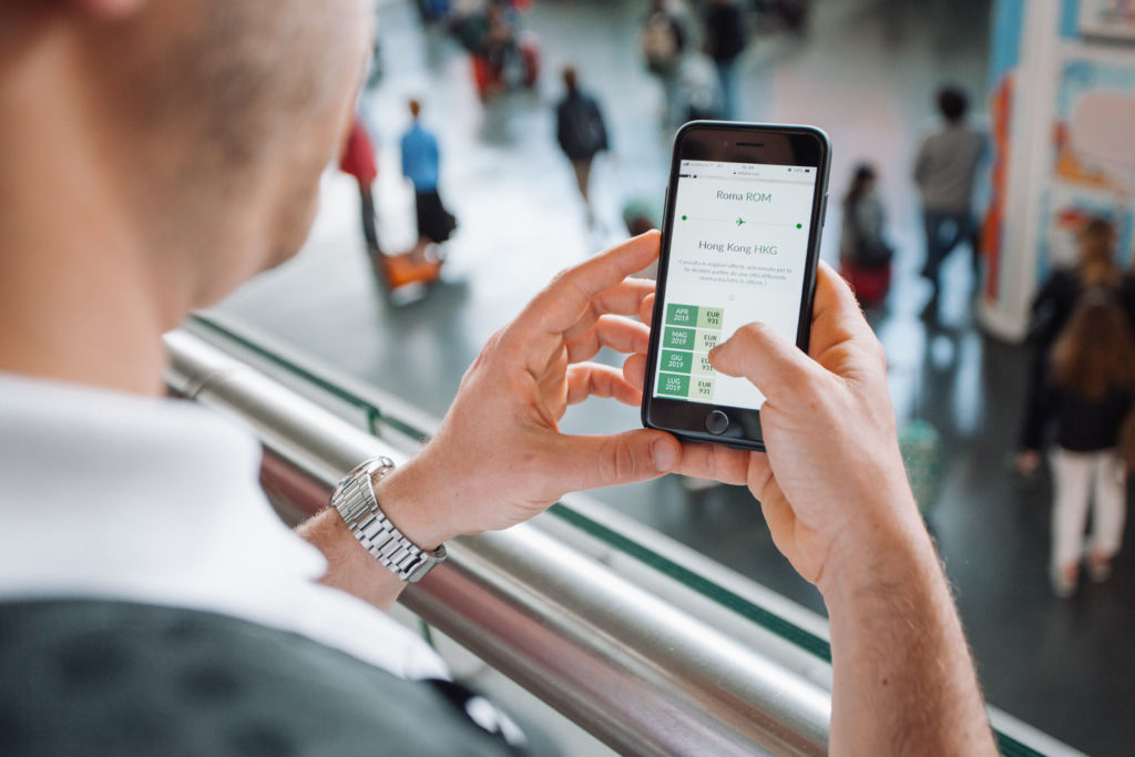 Man booking a flight on his phone