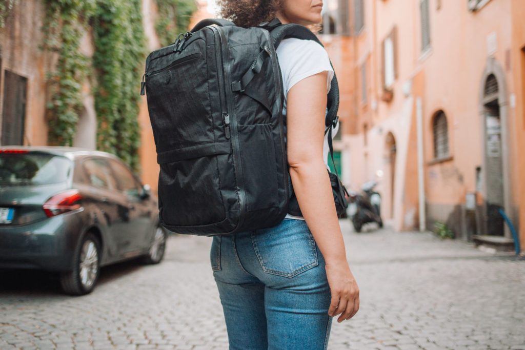 Woman wearing the Outbreaker Travel Backpack