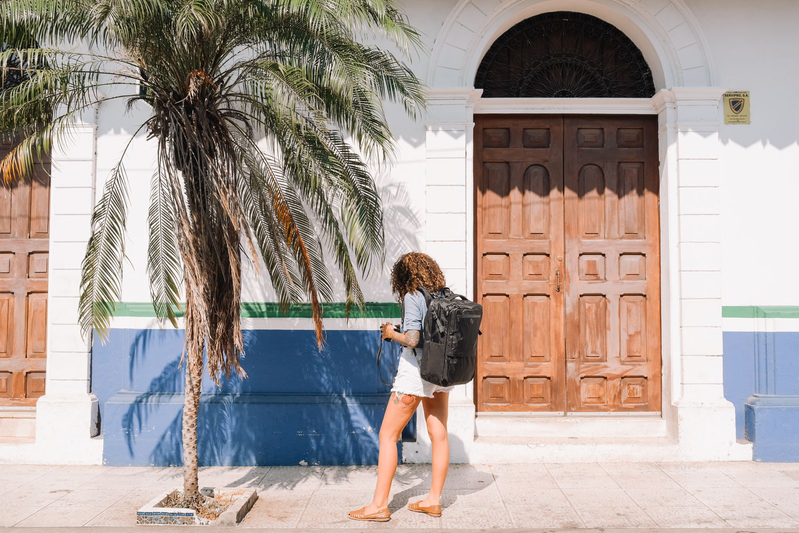 Woman walking near palm tree