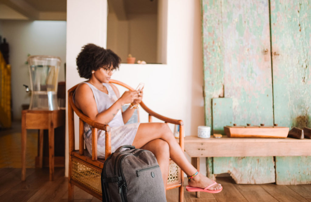 Woman seated using cell phone