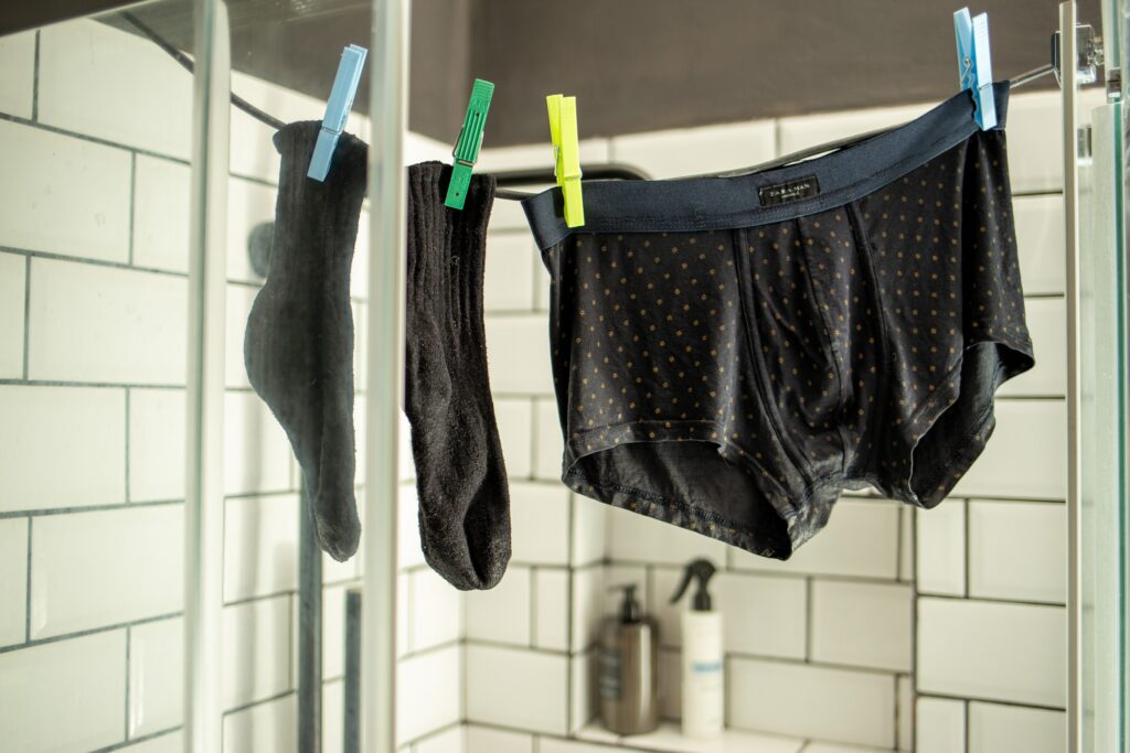 Clothes hanging to dry in the bathroom